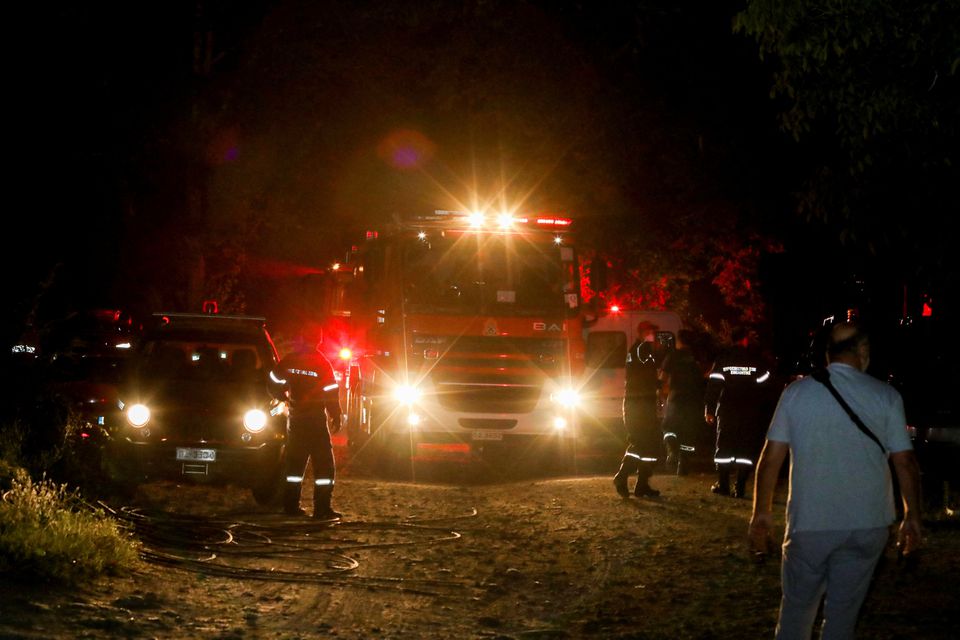 Firefighting vehicles and rescue crews are seen at the crash site of an Antonov An-12 cargo plane owned by a Ukrainian company, near Kavala, Greece, July 16, 2022. Photo: Laskaris Tsotsas/Eurokinissi via Reuters