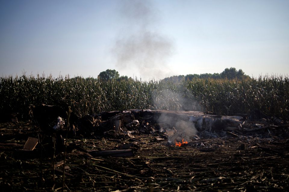 Debris burns at the crash site of an Antonov An-12 cargo plane owned by a Ukrainian company, near Kavala, Greece, July 17, 2022. Photo: Reuters