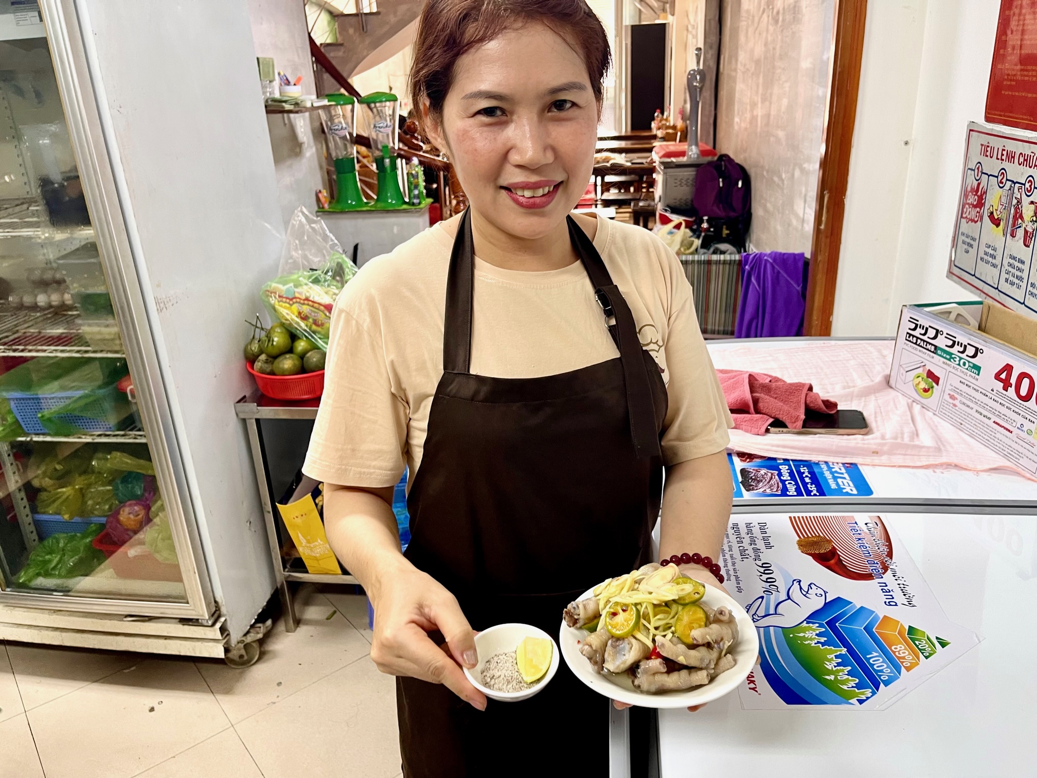 A woman serves 'chan ga sa tac' (boiled chicken feet topped with lemongrass shards and kumquat) at a shop in Phu Nhuan District in Ho Chi Minh City, Vietnam. Photo: Jordy Comes Alive
