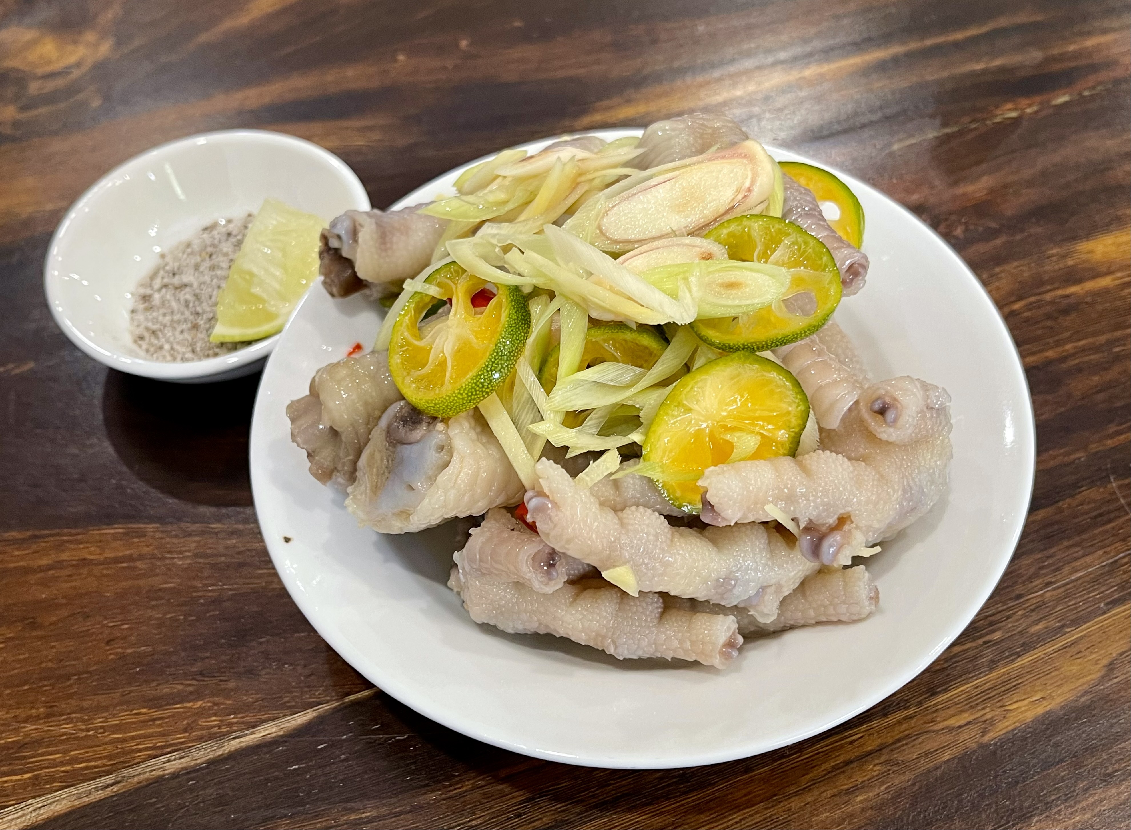 A dish of 'chan ga sa tac' (boiled chicken feet topped with lemongrass shards and kumquat) is served at a shop in Phu Nhuan District in Ho Chi Minh City, Vietnam. Photo: Jordy Comes Alive
