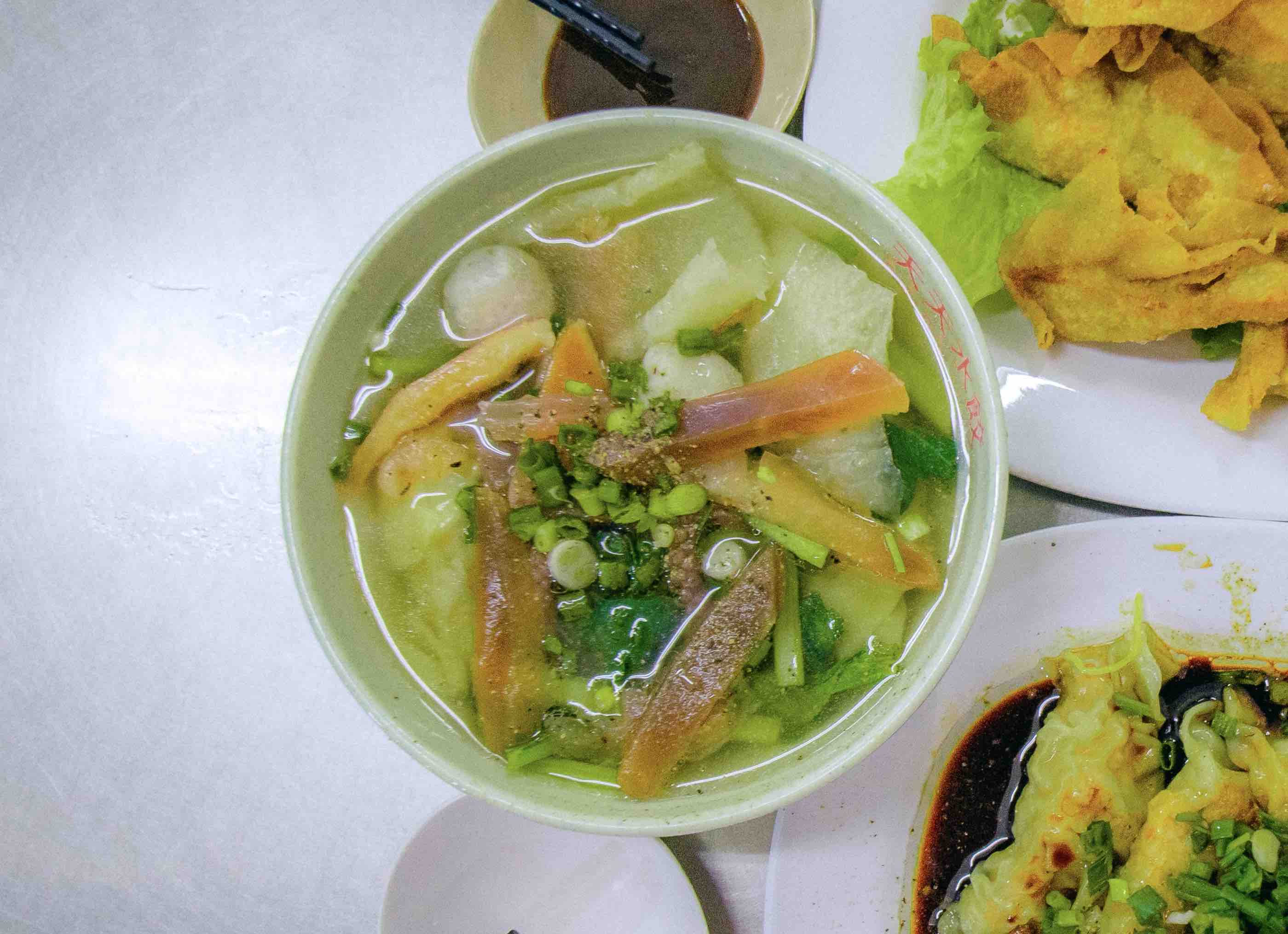A bowl of shuijiao topped with squid, fish ball and fish maw at a stall on Ha Ton Quyen Street, District 11, Ho Chi Minh City. Photo: Linh To / Tuoi Tre News