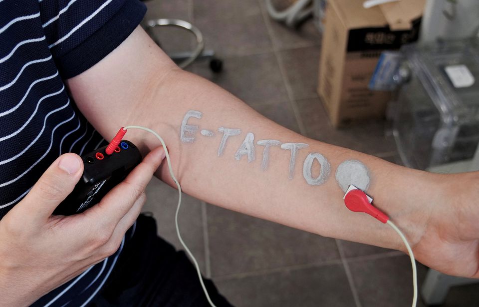 Steve Park, Materials Science & Engineering professor at Korea Advanced Institute of Science and Technology (KAIST), demonstrates an electronic tattoo (e-tattoo) on his arm connected with an electrocardiogram (ECG) monitoring system in Daejeon, South Korea, July 26, 2022. Photo: Reuters