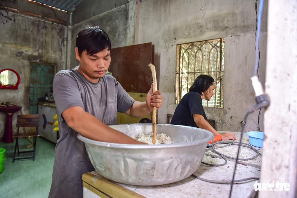 Huynh Thi Nhu Quyen and a volunteer prepare food for the rescued animals at her shelter in Cu Chi District, Ho Chi Minh City, Vietnam. Photo: Ngoc Phuong / Tuoi Tre
