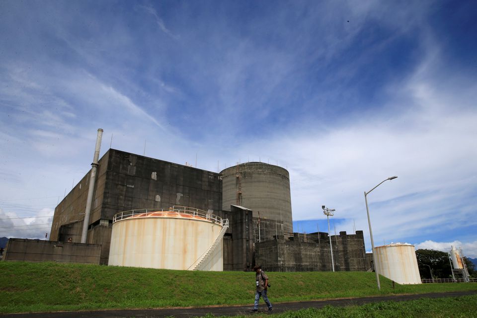 A local photographer walks past the Bataan Nuclear Power Plant (BNPP) during a media tour around the BNPP compound in Morong town, Bataan province, Philippines September 16, 2016. Photo: Reuters
