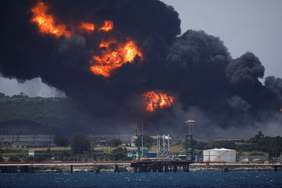 Fire is seen over fuel storage tanks that exploded near Cuba's supertanker port in Matanzas, Cuba, August 6, 2022. Photo: Reuters