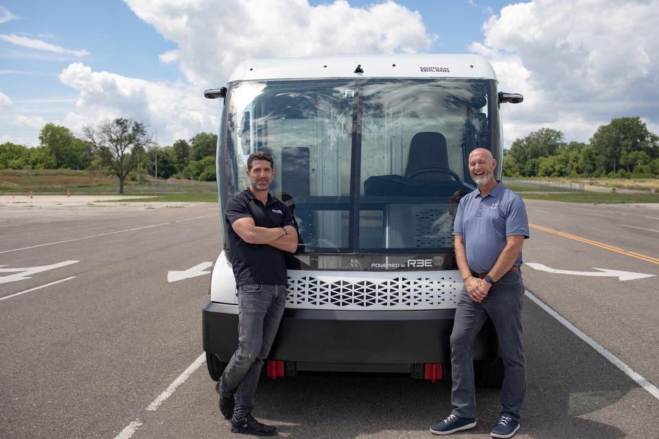 Daniel Barrel, CEO of REE Automotive stands Mark Hope, COO and GM of EAVX (with in front of an electric vehicle on display at the American Center for Mobility in Ypsilanti, Michigan, U.S. July 28, 2022. Photo: Reuters