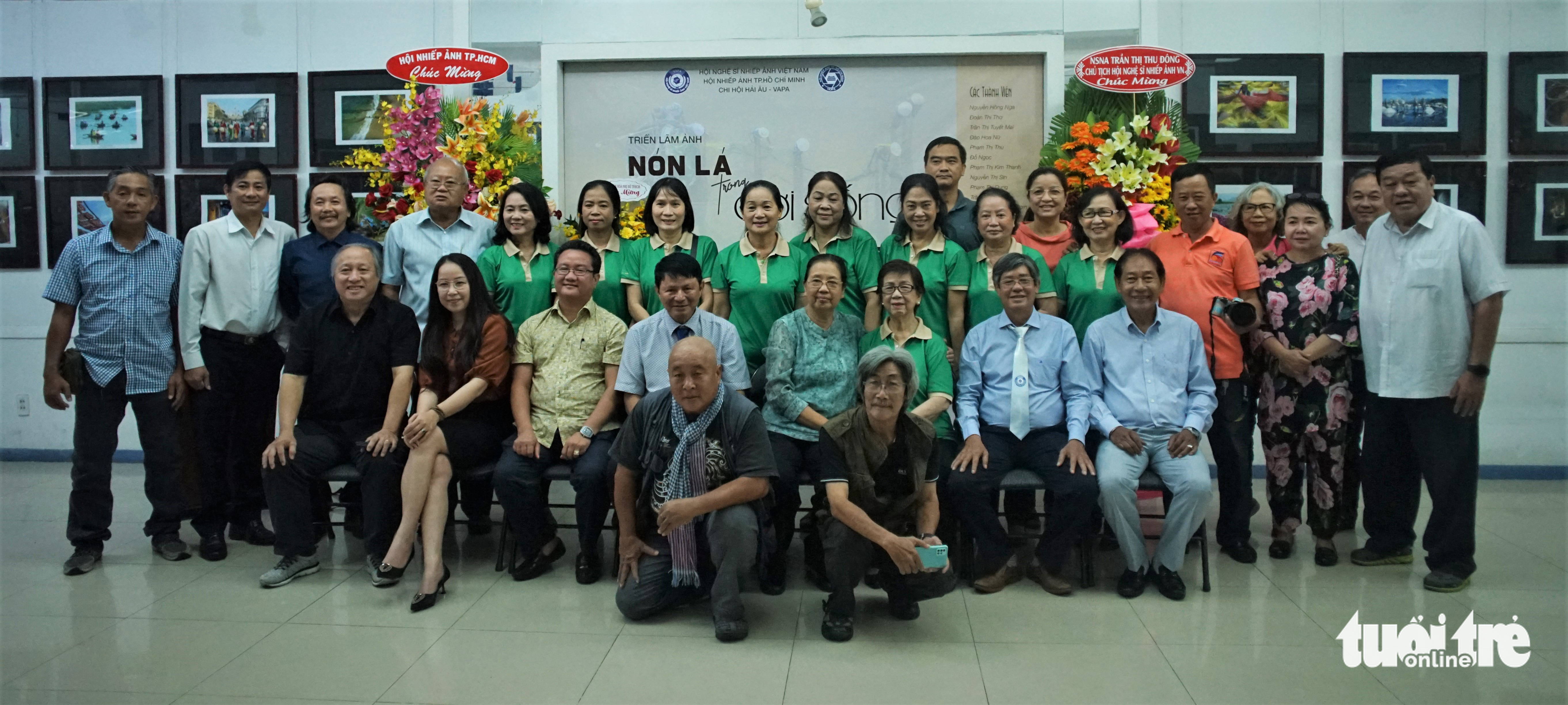 The exhibition’s featured photographers pose at the opening ceremony of the ‘Non la in life’ exhibition at the Ho Chi Minh City Photography Association (HOPA) headquarters, August 6, 2022. Photo: Huynh Vy / Tuoi Tre