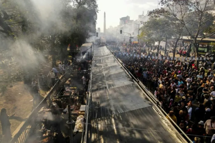 Festival-goers gathered along the capital city's main drag to watch the action, celebrating the country's gastronomic culture as the best barbecue chef in the nation was set to be crowned. Photo: AFP