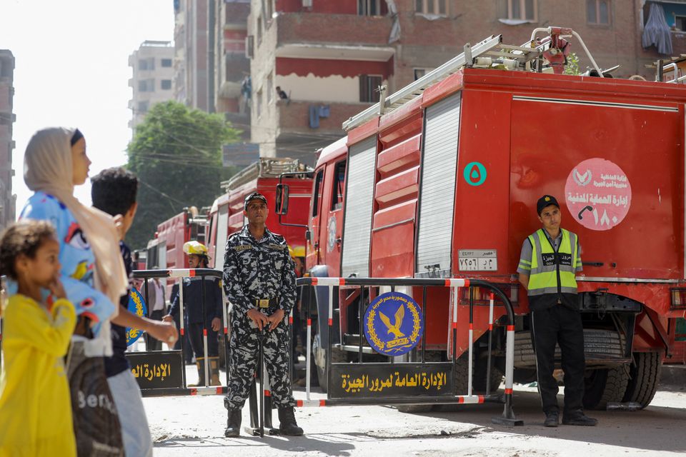 People and police gather near the scene where a deadly fire broke out at the Abu Sifin church in Giza, Egypt, August 14, 2022. Photo: Reuters