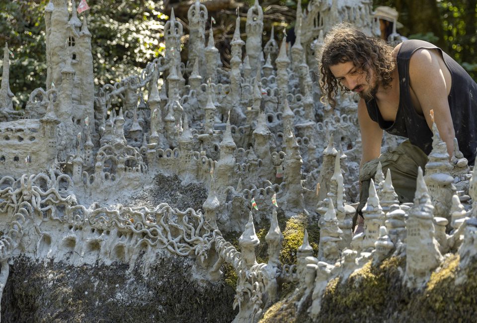 Land art artist Francois Monthoux works on his 'Monthoux castle' made out of clay retrieved from the dried bed of Le Toleure river due to ongoing drought, in Saubraz, Switzerland, August 12, 2022. Photo: Reuters