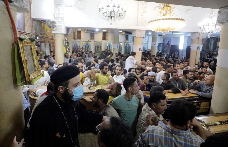 People react during the funeral of victims, who died due to the fire that broke out at the Abu Sifin church, inside the Church of the Blessed Virgin Mary at Warraq Al Arab district in Giza Governorate, Egypt, August 14, 2022. Photo: Reuters