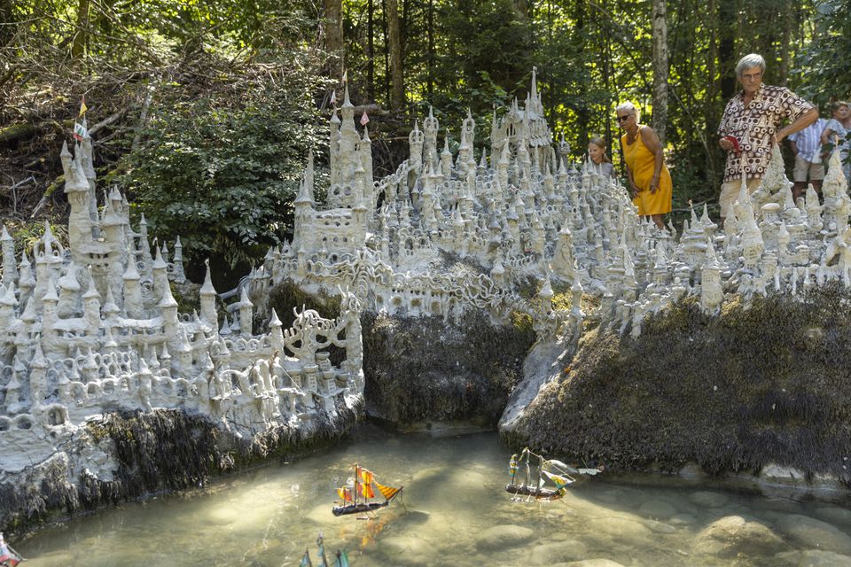 Swiss artist sculpts sprawling model castle on dried river bank