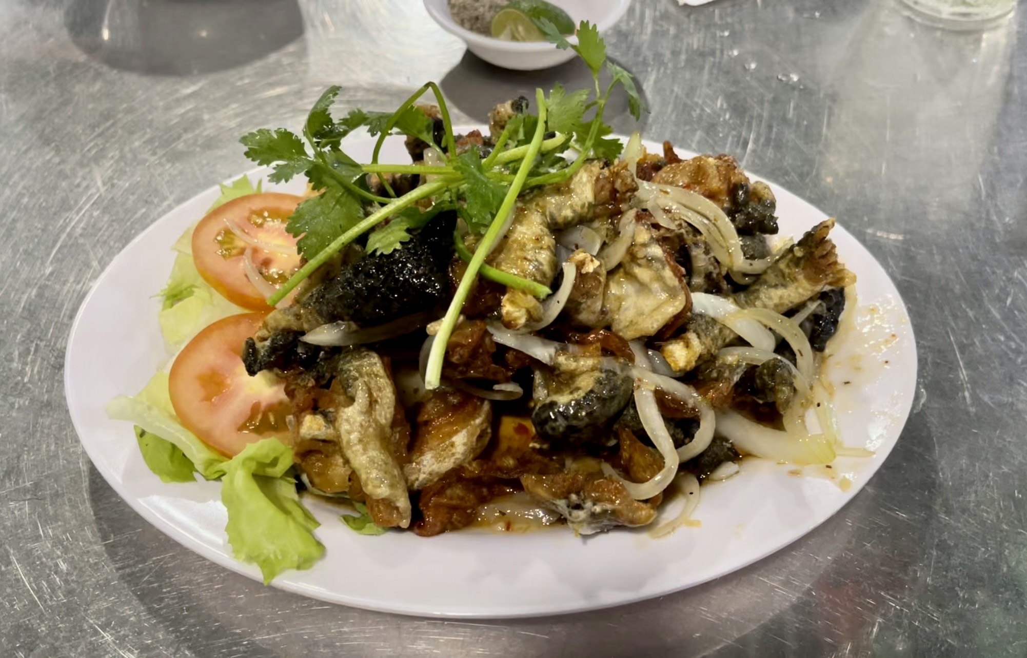 A dish of 'ech chien nuoc mam' (frog fried with fish sauce) is served at a shop in Binh Thanh District, Ho Chi Minh City, Vietnam. Photo: Jordy Comes Alive