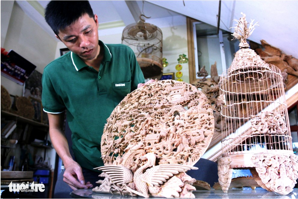 Exquisite carvings adorn Doan Minh Can’s Eighteen Arhat birdcage. Photo: N. Linh / Tuoi Tre