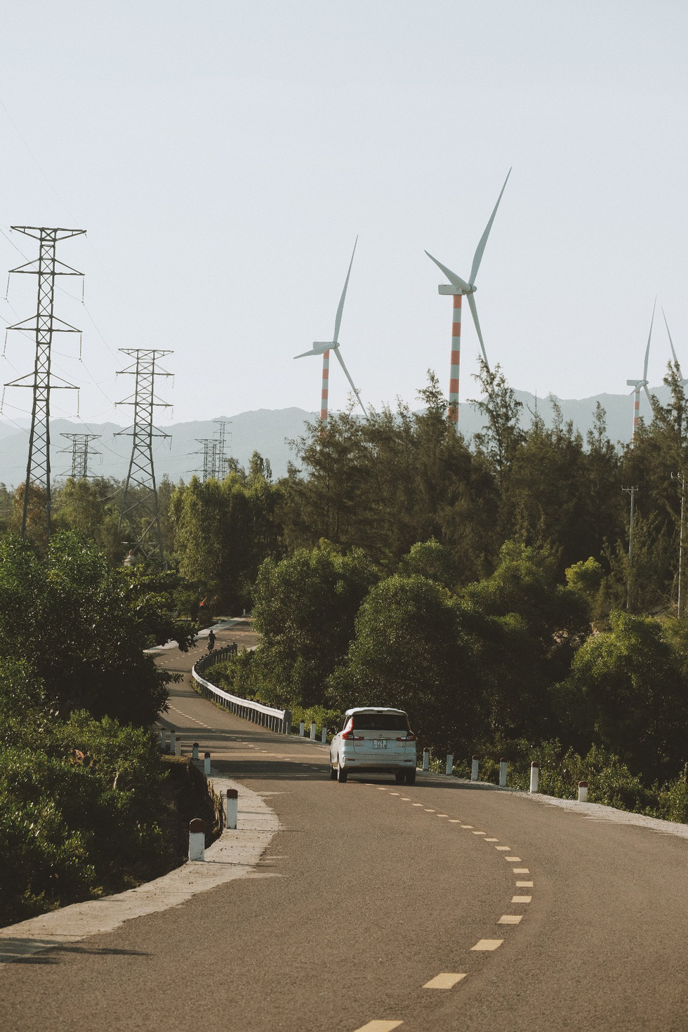 Vehicles travel against a background of wind turbines in Quy Nhon City, Binh Dinh Province, south-central Vietnam. Photo: Lo Huu Duc Anh / Tuoi Tre