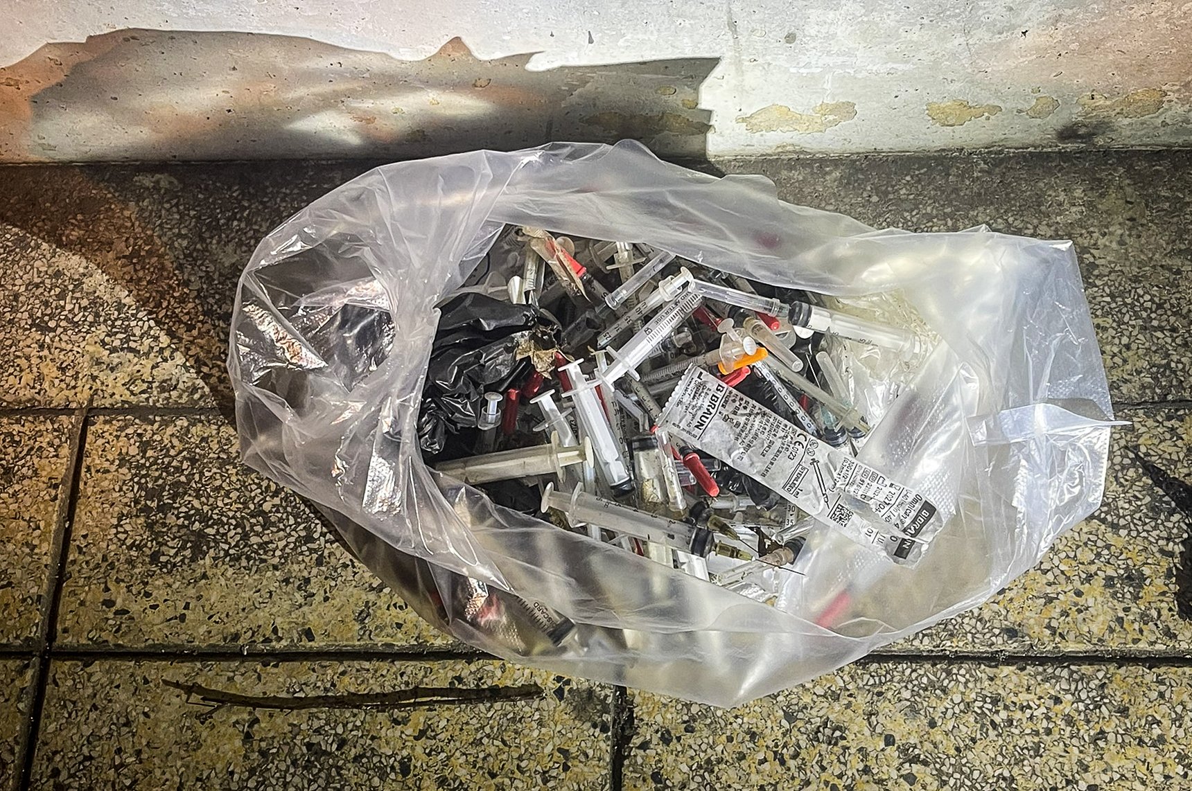 This supplied photo shows a plastic bag of used syringes collected by staff of the People's Committee of Ward 13 in Binh Thanh District, Ho Chi Minh City.
