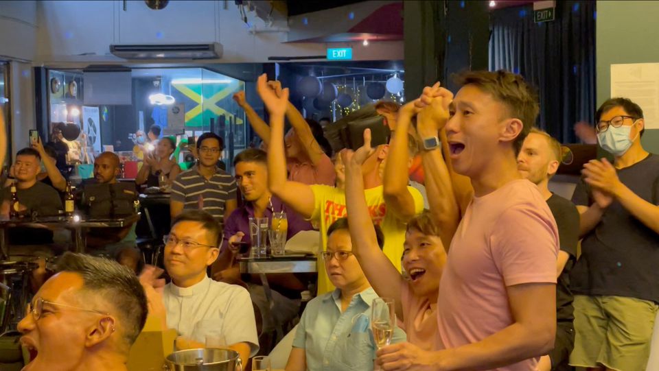 People cheer as Singapore's Prime Minister Lee Hsien Loong announces that Singapore will decriminalise gay sex, in Singapore, August 21, 2022, this screen grab obtained from a social media video. Boo Junfeng/via Reuters