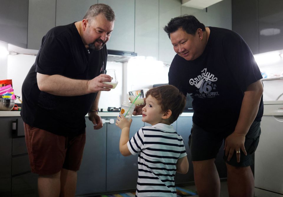 Same-sex parents Andre Ling, 44, and Cameron Sutherland, 47, make lemonade with their two year old son Tyler at home in Singapore, August 22, 2022. Photo: Reuters