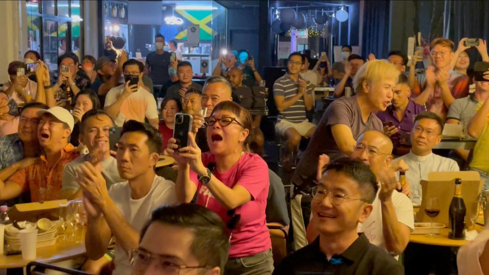 People cheer as Singapore's Prime Minister Lee Hsien Loong announces that Singapore will decriminalise gay sex, in Singapore, August 21, 2022, this screen grab obtained from a social media video. Boo Junfeng/via Reuters