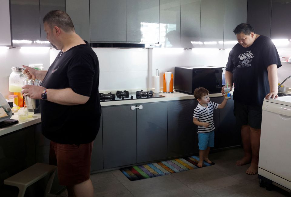 Same-sex parents Andre Ling, 44, and Cameron Sutherland, 47, make lemonade with their two year old son Tyler at home in Singapore August 22, 2022. Photo: Reuters