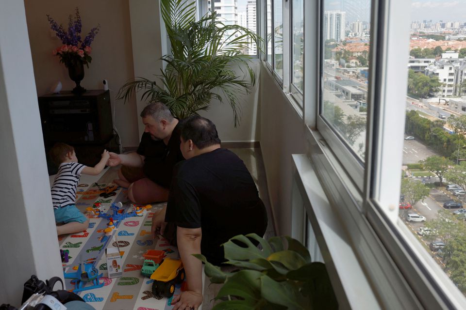 Same-sex parents Andre Ling, 44, and Cameron Sutherland, 47, play with their two year old son Tyler at home in Singapore, August 22, 2022. Photo: Reuters