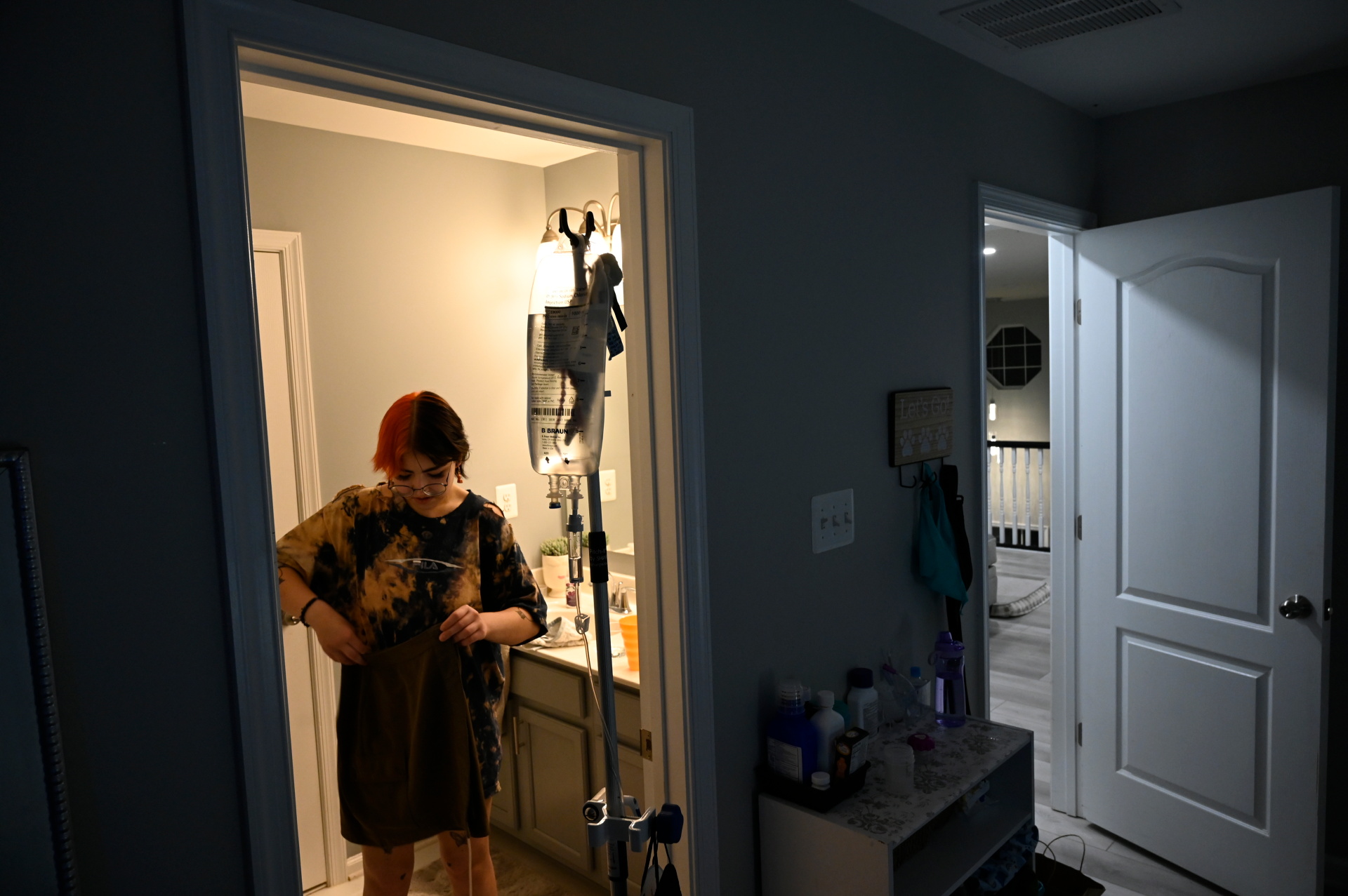 Kelble tidies up their room while they carry their IV bag, at their previous house in Easton, Maryland, May 13, 2022. Photo: Reuters