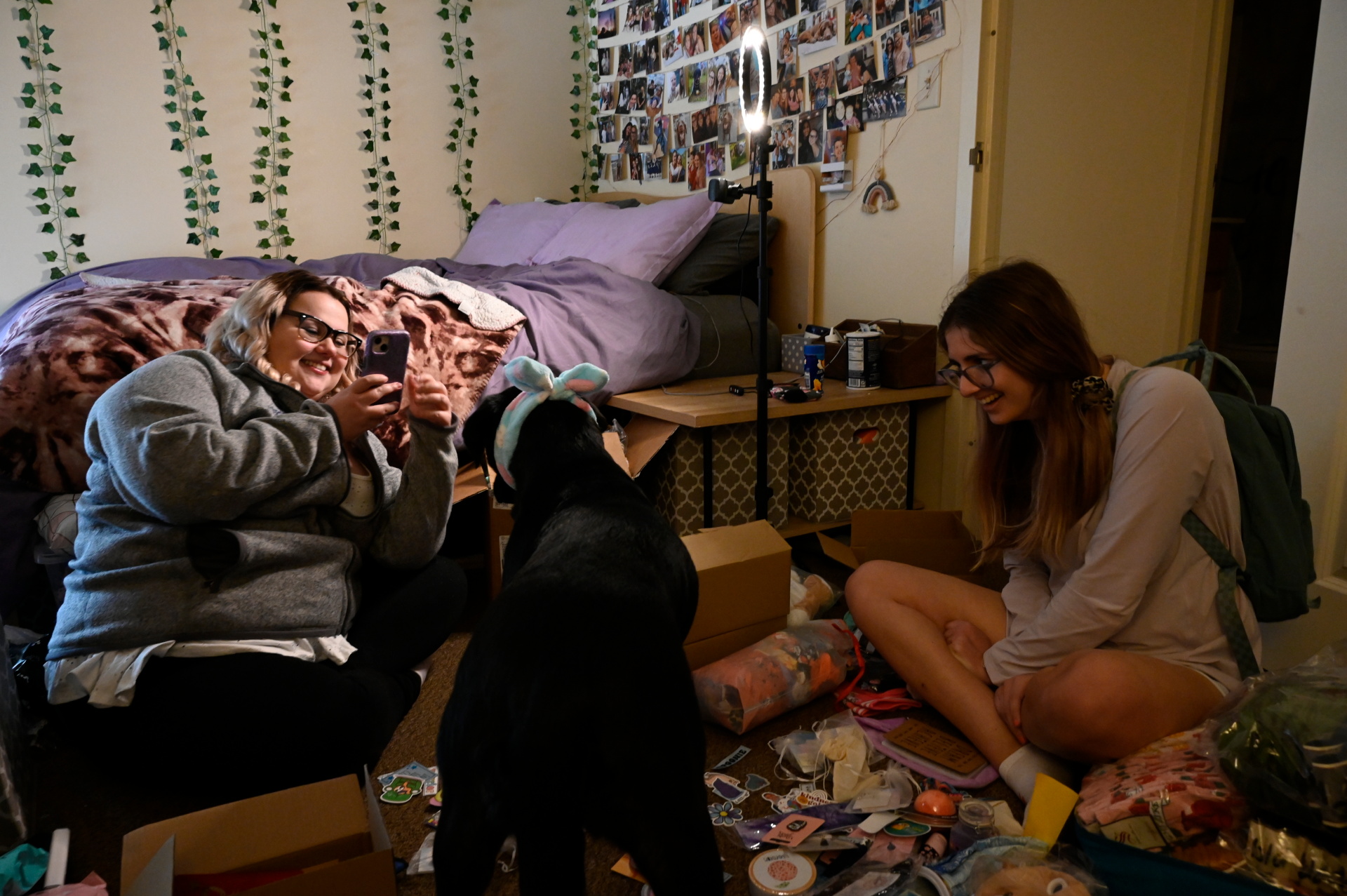 Spencer photographs her dog while preparing a package containing medical and motivational accessories for Shannon McMullen, 20, who has the same medical condition as Nicole, at her apartment in Syracuse, New York, May 6, 2022. Photo: Reuters