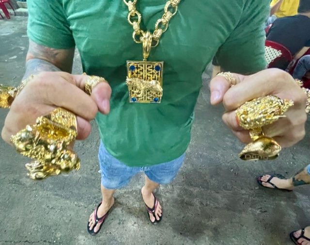 A close-up to the jewelry, rumored to be worth over US$250,000, Dung's wearing when serving the food at his snail stall in District 3, Ho Chi Minh City.  Photo: Jordy Comes Alive