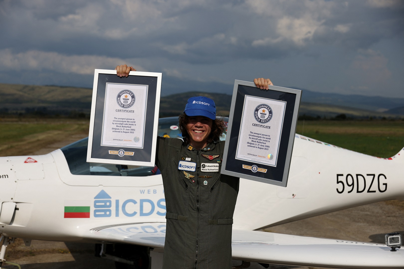 Mack Rutherford poses with Guiness World Record certificates after his arrival at an airport near Radomir, Bulgaria, August 24, 2022. Photo: Reuters