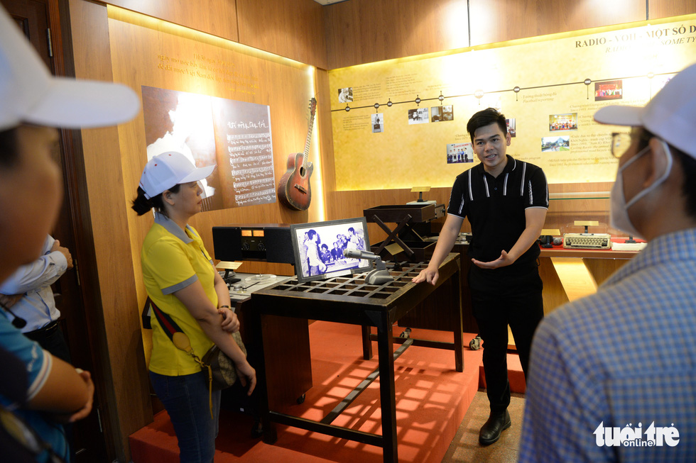 Tourists listen to a guide while visiting the Saigon Radio Station (VOH) as part of the ‘Memories of Saigon Commando’ tour in Ho Chi Minh City in August 2022. Photo: T.T.D / Tuoi Tre