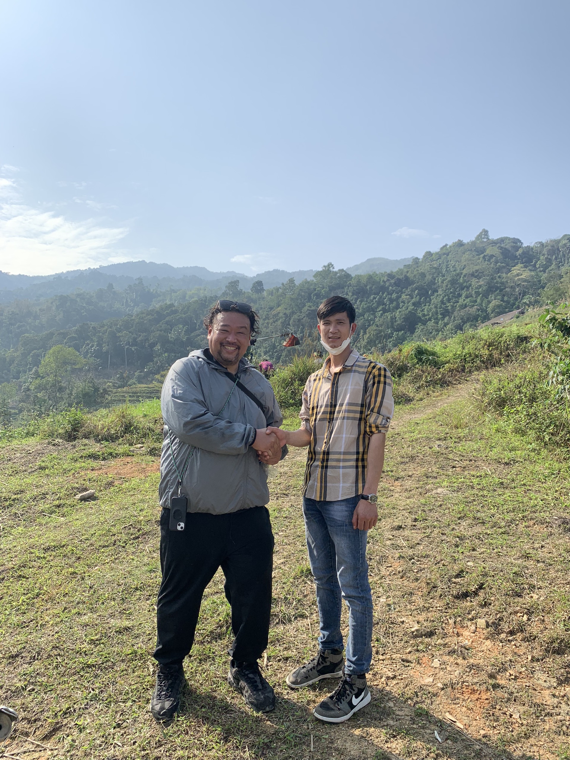Matsuo Tomoyuki (left) poses for a photo with Hoang Van Chung, who is in charge of the buckwheat cultivation project on 50 hectares for JVGA in Phuong Thien Commune, Ha Giang Province, in a provided photo.