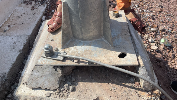 Thieves removed a bolt from a light pole installed along the Van Don - Mong Cai Expressway to steal electric cables in Quang Ninh Province, Vietnam. Photo: Do Phuong / Tuoi Tre