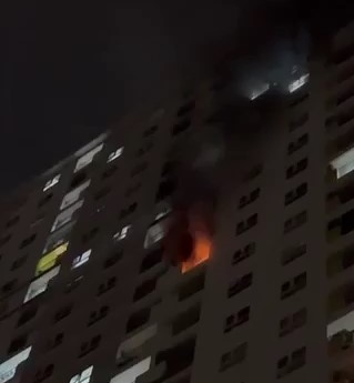 Smoke comes out from the apartment fire at Diamond Riverside apartment complex in District 8, Ho Chi Minh City, September 10, 2022 in this screenshot taken from a video clip.