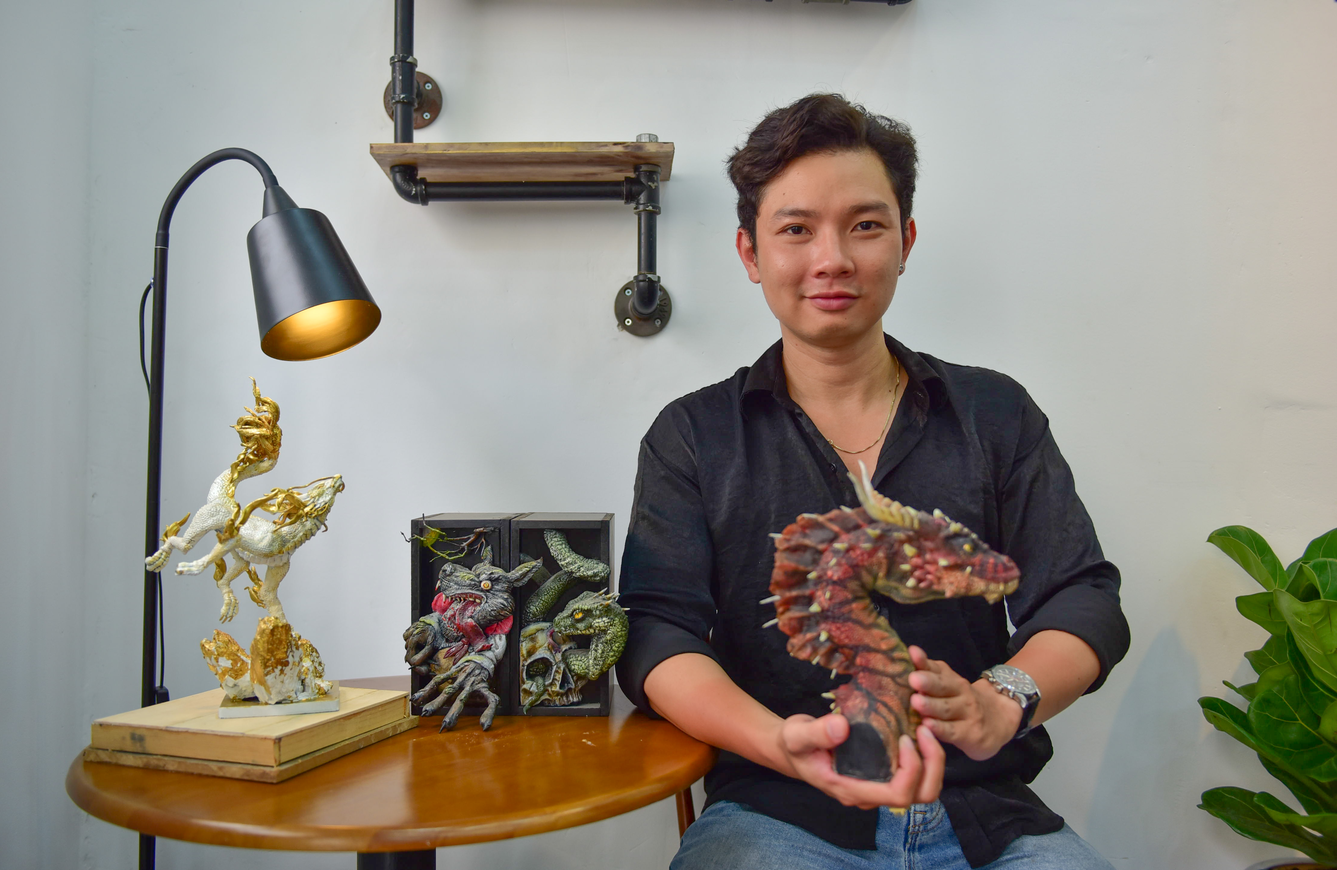Nguyen Hai Au and his models of mythical creatures. Photo: Ngoc Phuong / Tuoi Tre News