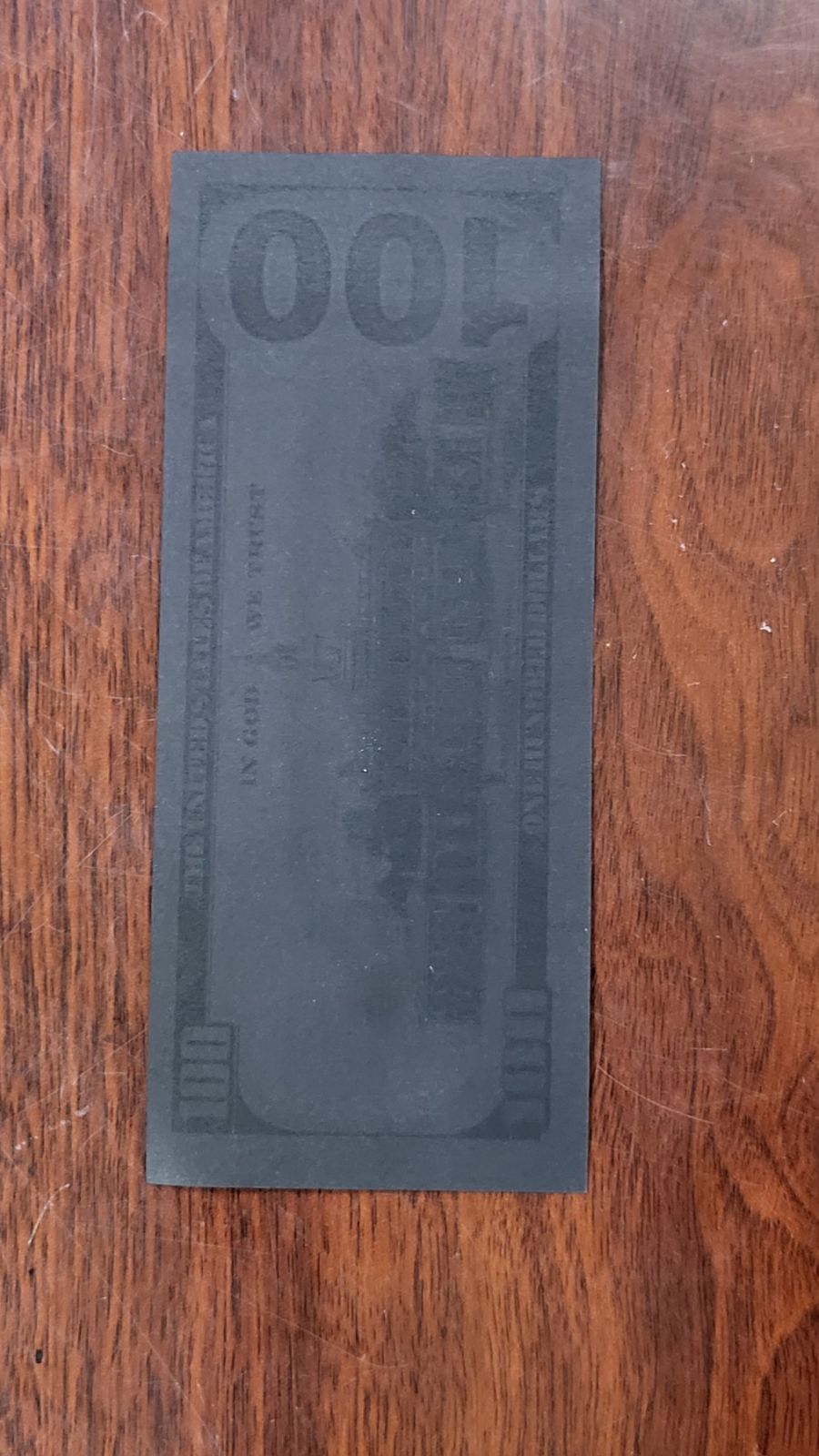 A suspected $100 banknote that had been dyed black in this supplied photo