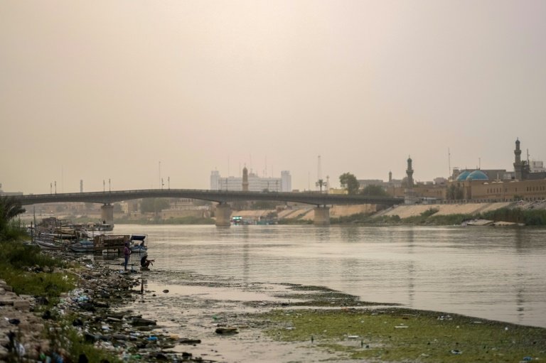 Thinning and polluted: the Tigris River flows under the Ahrar bridge in central Baghdad. Photo: AFP