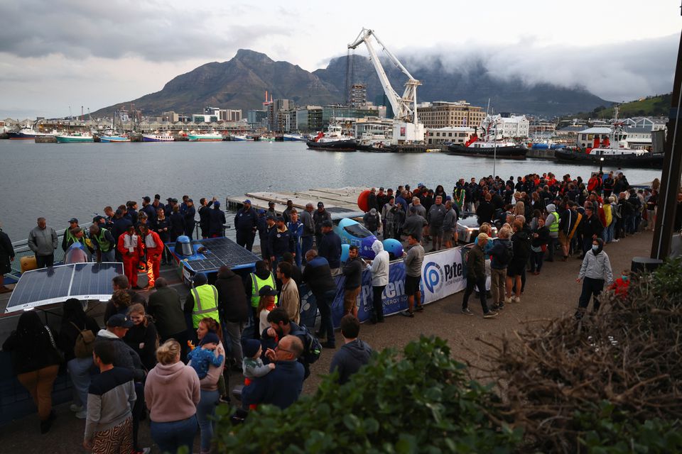 Participating teams stand at the finish line at the V&A Waterfront after completing the final stage of the 2022 Sasol Solar Challenge race in Cape Town, South Africa, September 16, 2022. Photo: Reuters