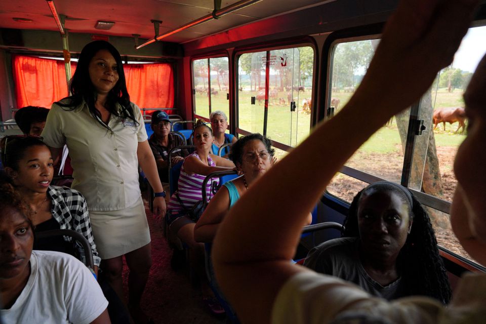 A group of partial hearing visitors look at sign language interpreter Yoandra Oliva during a tour in an enclosed plain at the Cuba's national zoo in Havana, Cuba, September 21, 2022. Photo: Reuters