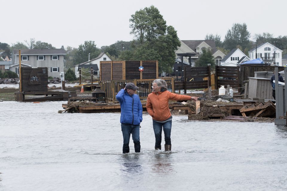Residents stand in flood waters following the passing of Hurricane Fiona, later downgraded to a post-tropical cyclone, in Shediac, New Brunswick, Canada September 24, 2022. Photo: Reuters
