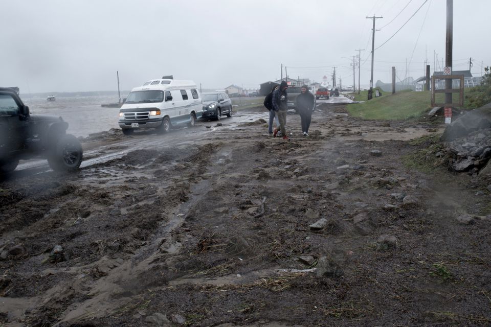 Residents walk on the damaged shoreline following the passing of Hurricane Fiona, later downgraded to a post-tropical cyclone, in Shediac, New Brunswick, Canada September 24, 2022. Photo: Reuters