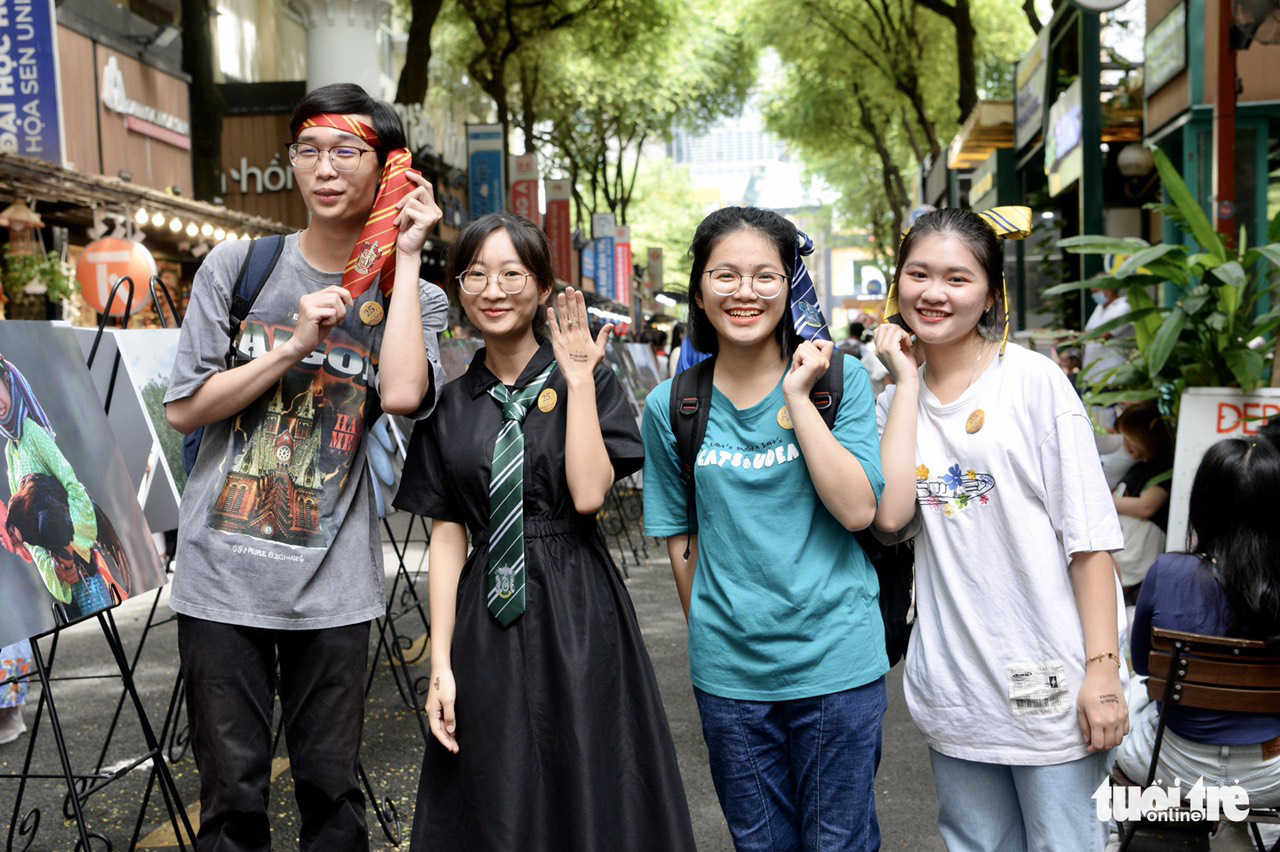 Young people pose for a photo with accessories from Harry Potter books, a best-selling series by British author J.K. Rowling, at Nguyen Van Binh Book Street in Ho Chi Minh City, September 25, 2022. Photo: T.T.D. / Tuoi Tre