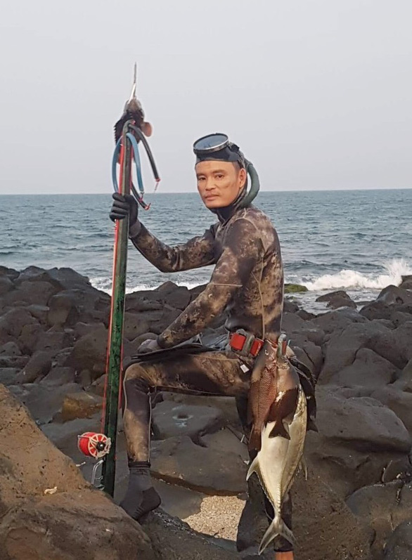 Nguyen Van Dieu trains other people on the island on how to dive and hunt underwater.