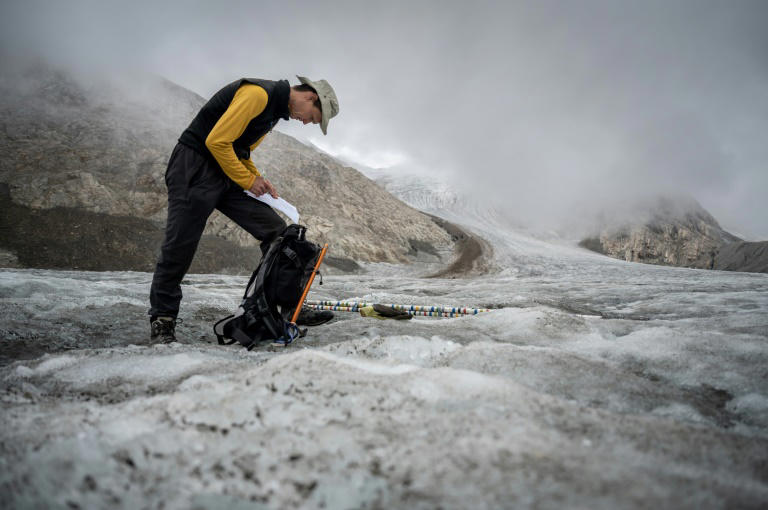 This picture taken on September 2, 2022 above Ulrichen shows glaciologist and head of 'Glacier Monitoring in Switzerland' (GLAMOS) network Matthias Huss during a visit with his team on the Gries glacier to takes readings of measuring equipment. Photo: AFP