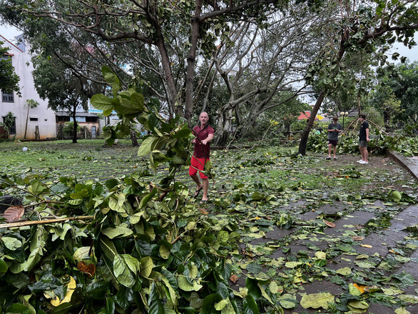 A group of Australian visitors pick up tree branches in Cam Chau District, Hoi An City, Vietnam, September 28, 2022. Photo courtesy of Mai Thanh Chuong