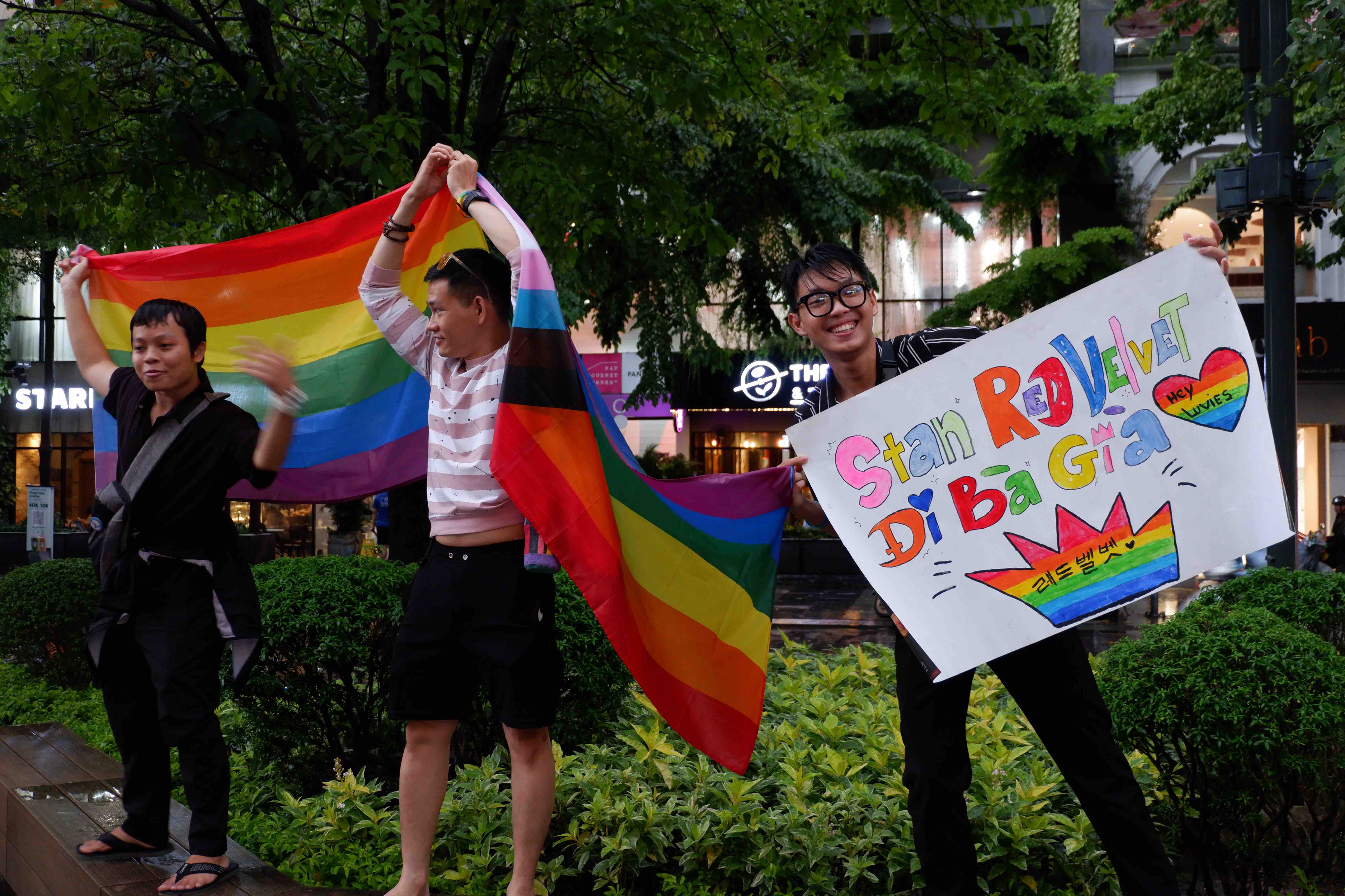 Participants hold flags and banner to show support for freedom and equality LGBT community during the VietPride parade in Ho Chi Minh City on October 1, 2022. Photo: Linh To / Tuoi Tre News