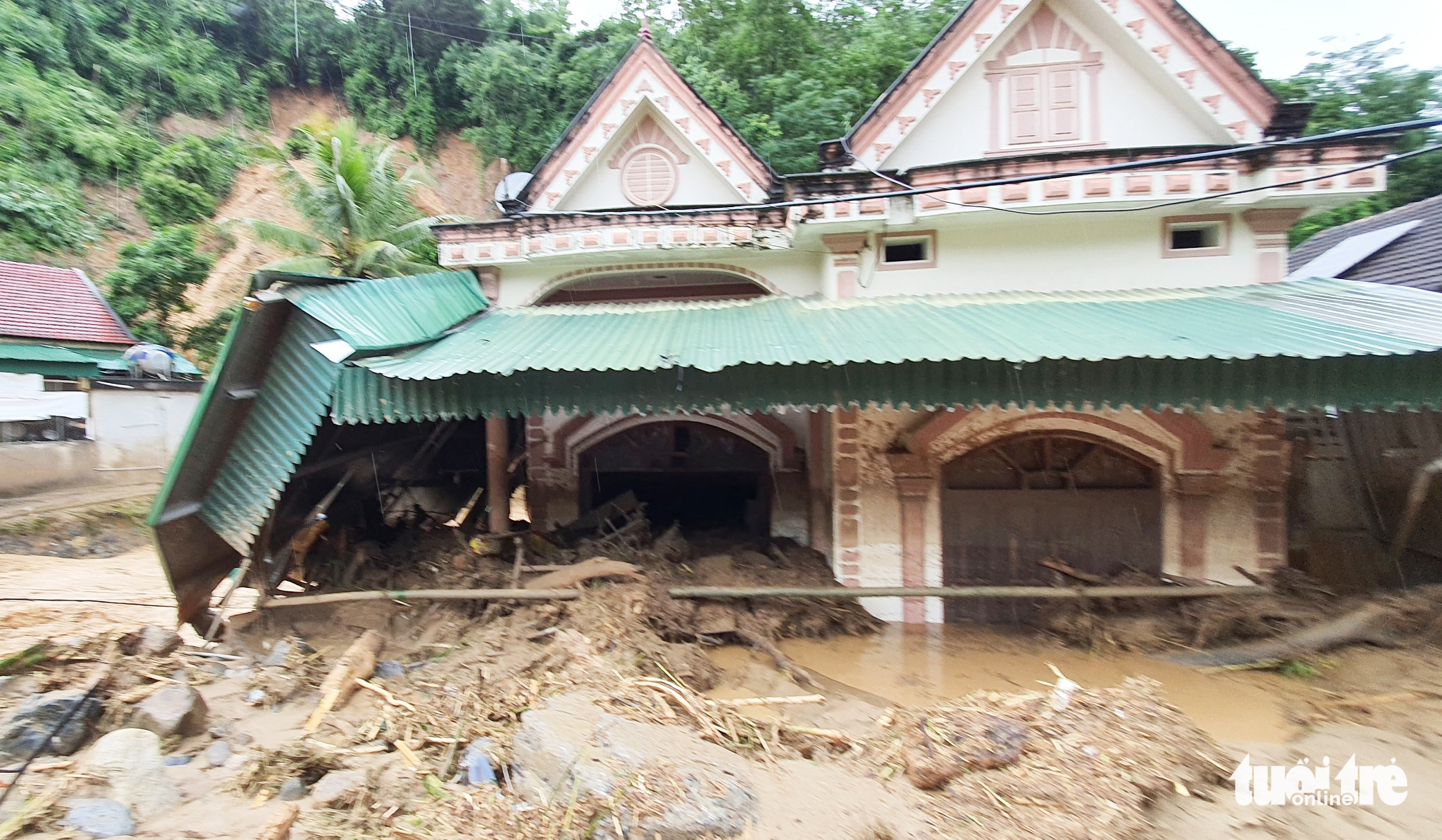 Debris spills into a house following a flash flood in Ky Son District, Nghe An Province, Vietnam, October 2, 2022. Photo: Duong Tinh / Tuoi Tre