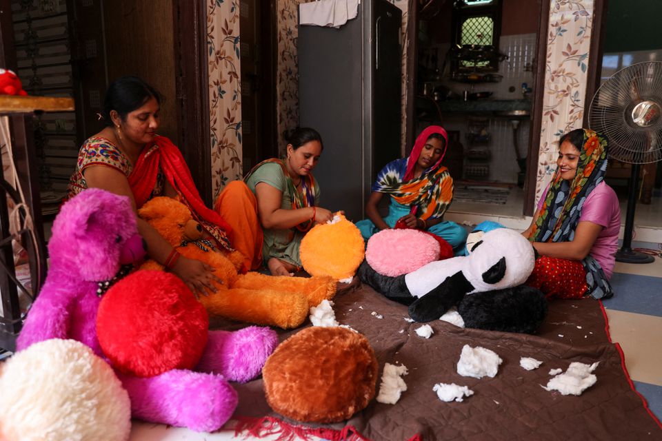 Women workers make soft toys using recycled fibre separated from cigarette filter tips at a cigarette butts recycling factory in Noida, India September 12, 2022. Photo: Reuters