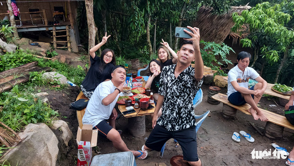 A group of tourists take a selfie at a homestay in Cam Mountain, An Giang Province, Vietnam. Photo: Buu Dau / Tuoi Tre