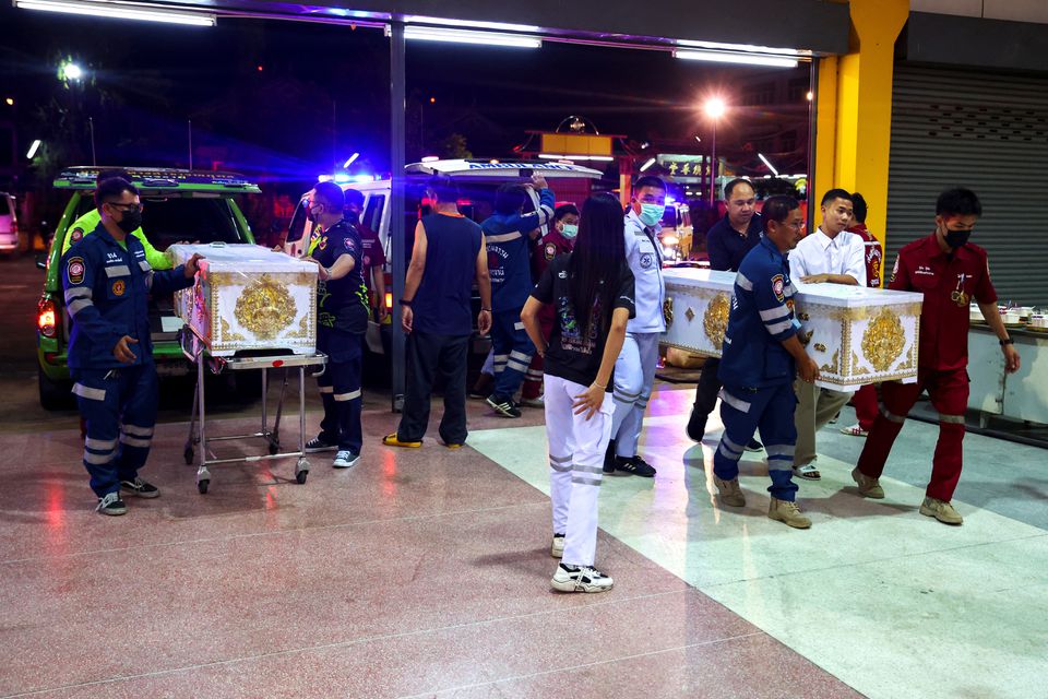 Rescue workers carry coffins containing the body of victims at Song Serm Tham Foundation after transfer from Udon Thani hospital in Udon Thani province, following a mass shooting in the town of Uthai Sawan, around 500 km northeast of Bangkok in the province of Nong Bua Lam Phu, Thailand October 7, 2022. Photo: Reuters