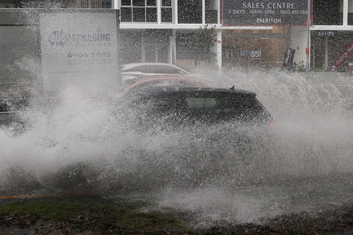 Vehicles drive through floodwaters as heavy rains affect Sydney, Australia, October 6, 2022. Photo: Reuters